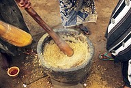 Ghana: Techiman (Brong-Ahafo Region), peanut powder “Kuli Kuli” being ground in mortar with pestles