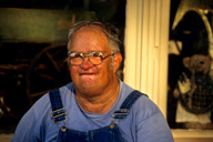 Missouri: Caledonia, old farmer sitting on porch of country store on Main Street