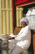 Dairy lab worker with milk cans being loaded onto Brookside truck.