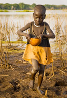 Lebuk farm villager collecting a gourd full of water